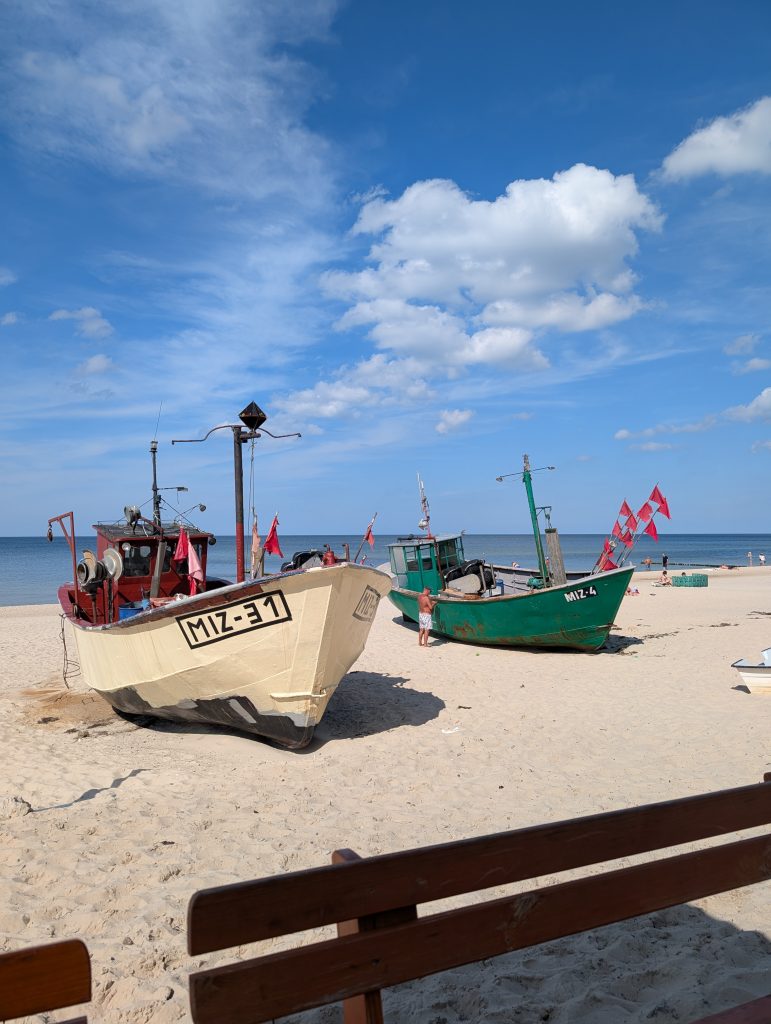Die Fischkutter MIZ-31 und die grüne MIZ-4 am Sandstrand von Misdroy unter blauem Himmel